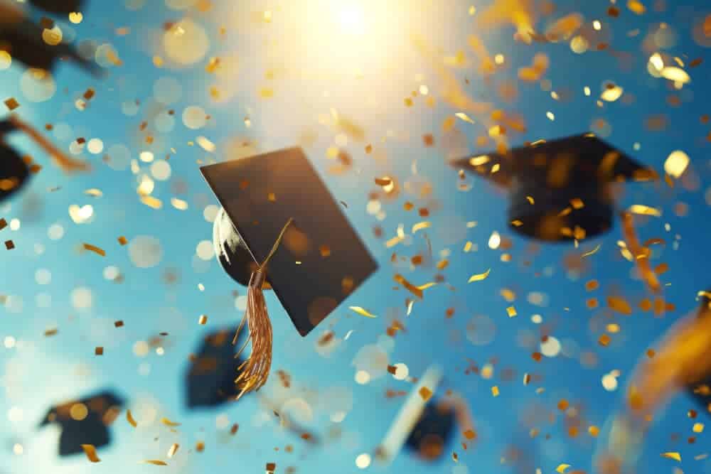 Graduation cap thrown in the air with confetti, symbolizing successful completion of a sociology degree.